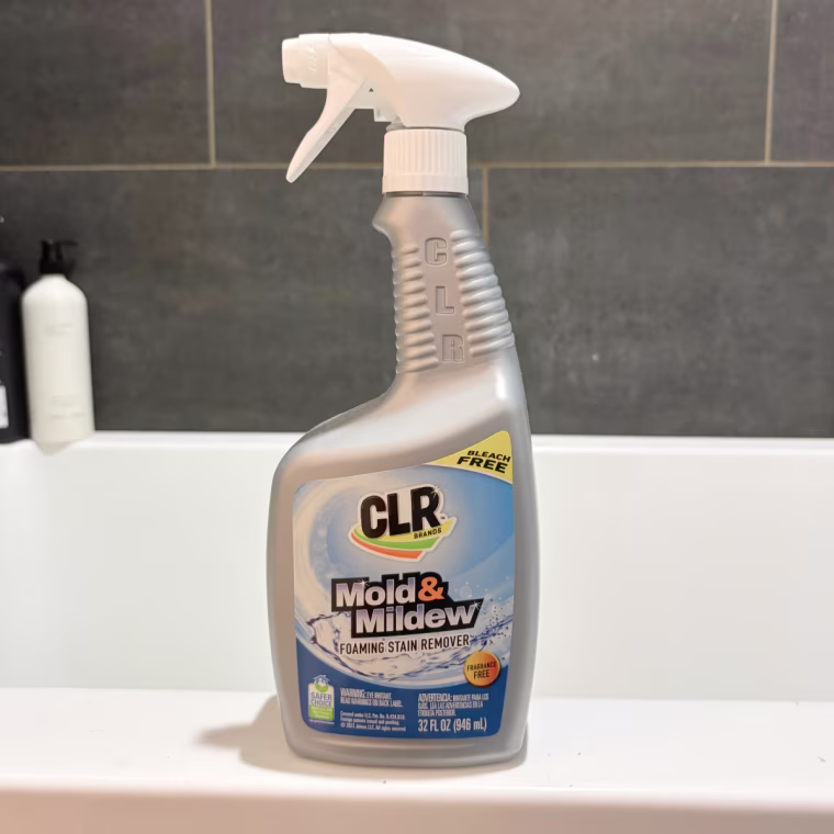 CLR Mold & Mildew Foaming Stain Remover sitting on the side of a tub.