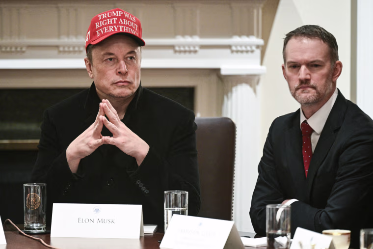 Elon Musk, left, and Jamieson Greer sit at a table