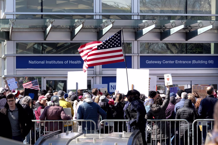 Demonstrators protest funding cuts outside of the National Institutes of Health (NIH) in Bethesda, Maryland, on March 8.