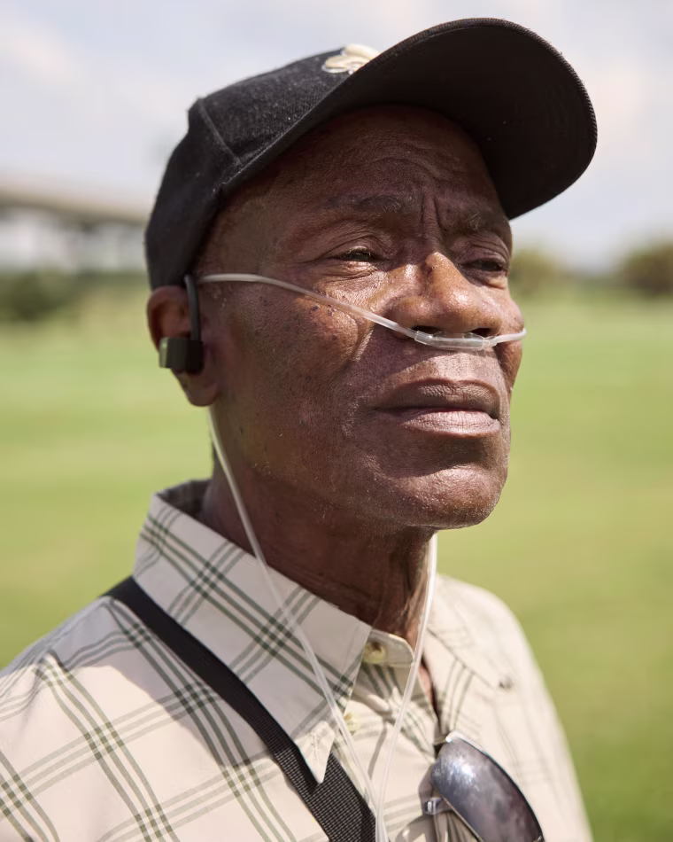 Willie Youngblood, who has lived across the river from Atlantic Alumina for the last thirty years, carries his oxygen tank with him wherever he goes: “I’ve always got to have this with me.” 