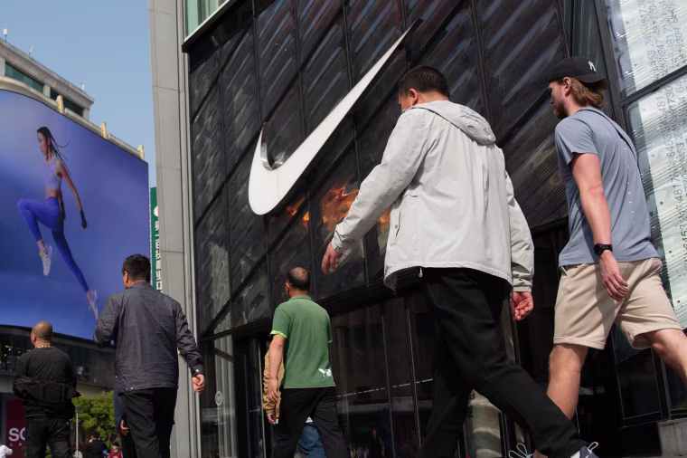 Tourists walk in front of a Nike retail store in Shanghai, China, on April 6, 2025.