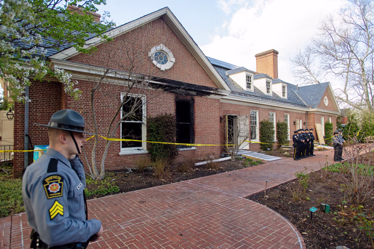 Police stand in front of extensive fire damage to the Pennsylvania Governor's Mansion and Gov. Josh Shapiro's residence on April 13, 2025 in Harrisburg, Pa.