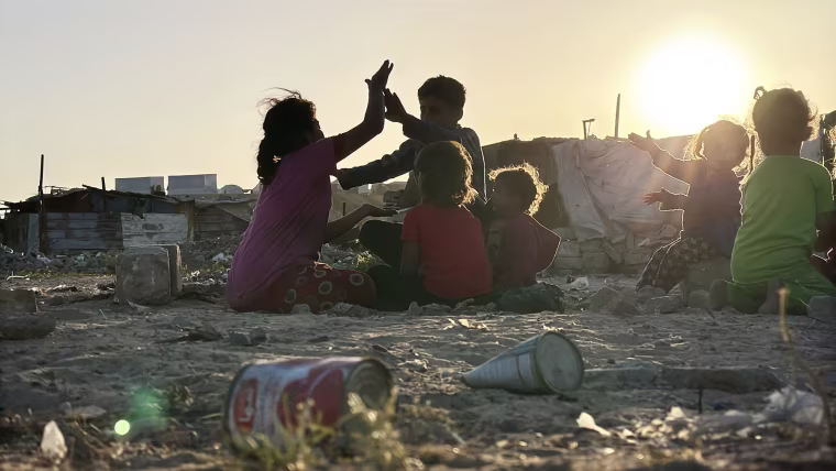The children play as the sun sets.