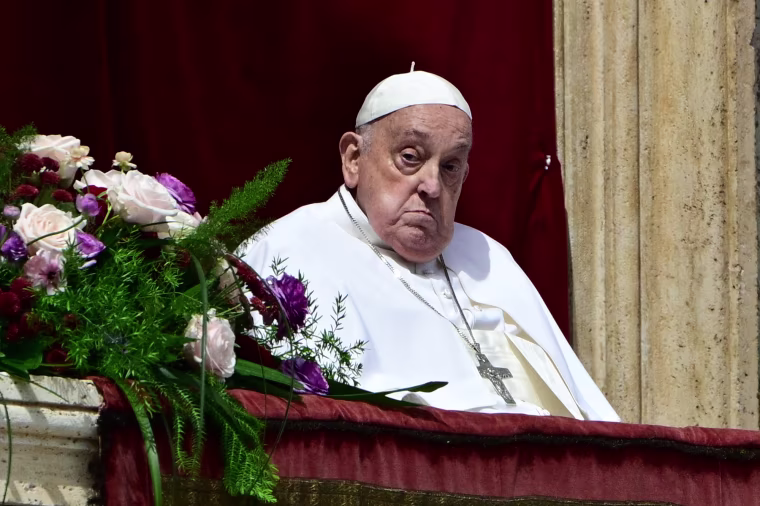 Pope Francis sits outside on a balcony
