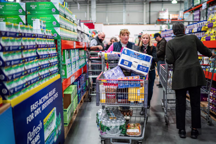 Customers shop in an aisle at the store