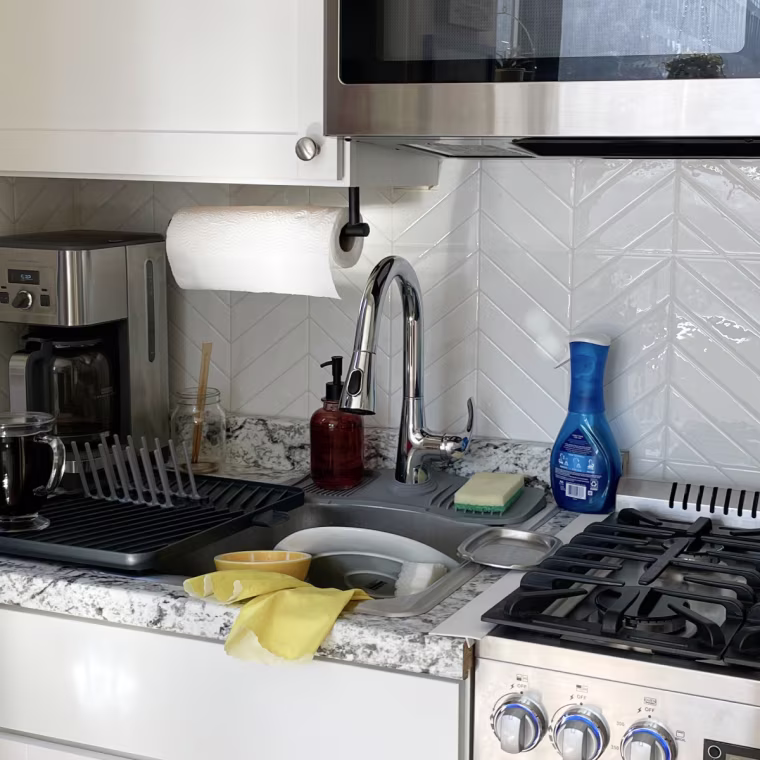 White kitchen geometric backsplash over a stovetop.