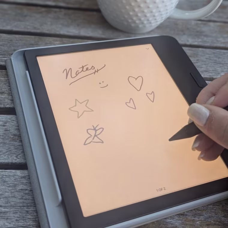 A close up image of someone using a stylus to draw doodles on the Kobo Libra Colour.