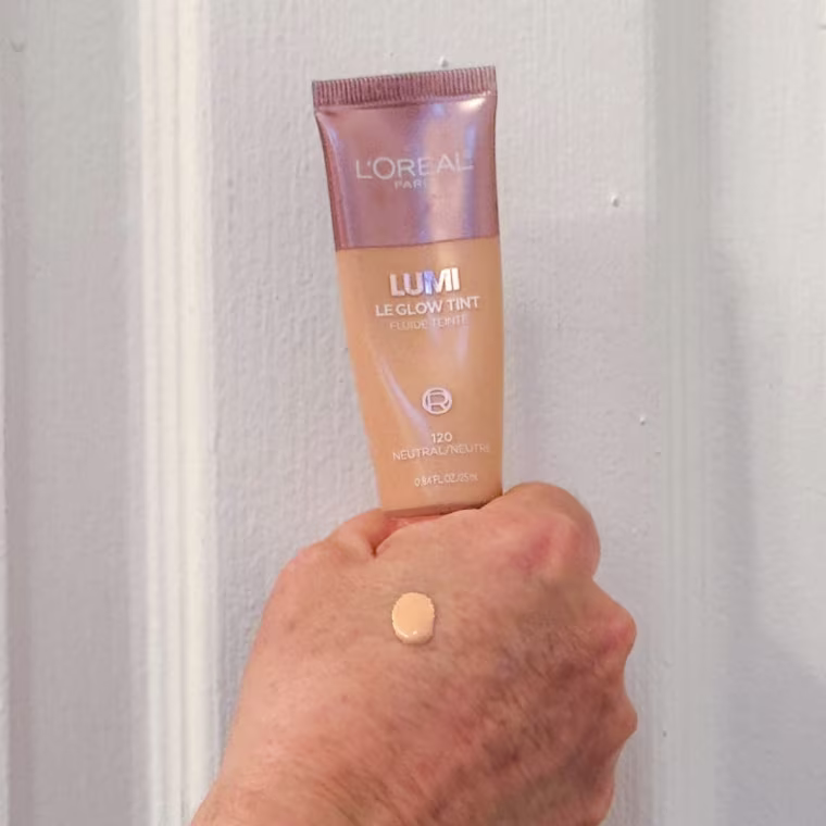 Applying the L’Oreal Paris Lumi Le Glow Tint in 120 Neutral.