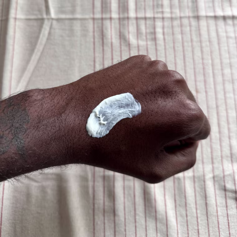 Man swatches a La Roche Posay Toleriane Double Repair Moisturizer with SPF on his hand.