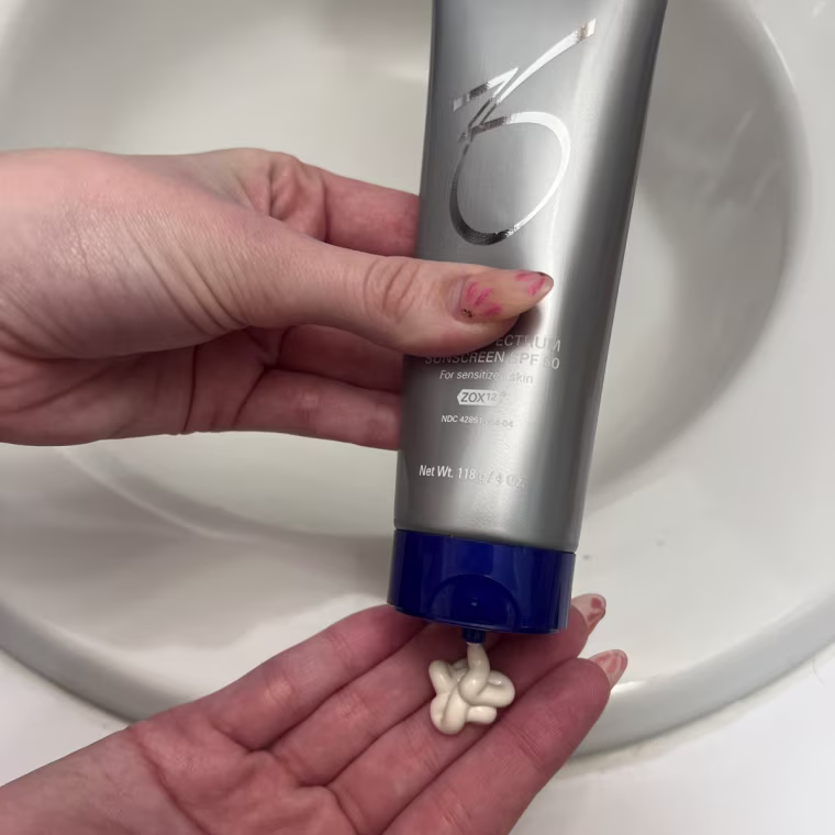 Woman applying sunscreen to her hand.
