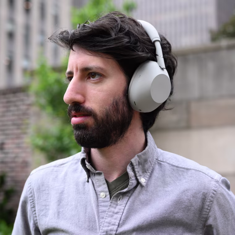 Close up, in-profile shot of the Sony WH-1000XM6 headphones worn by the writer.