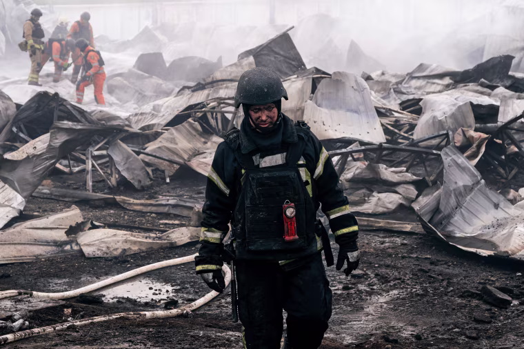 Firefighters extinguish a fire at a plastic tableware business damaged by Russian drone attack