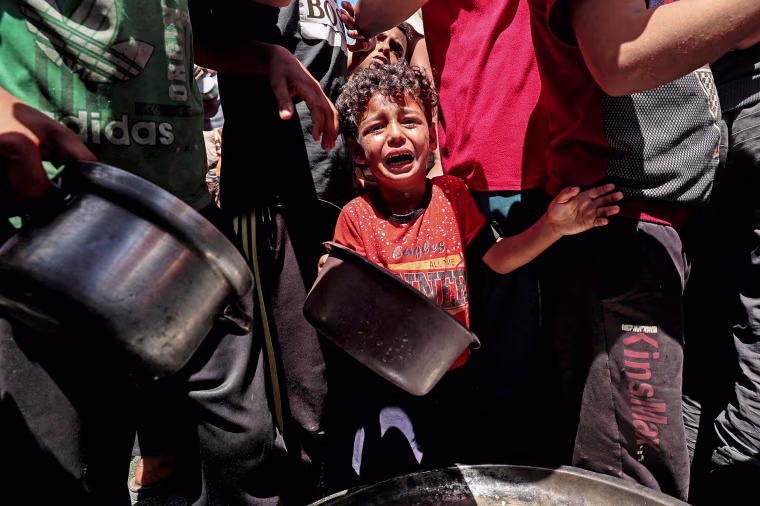 A child cries at a food distribution point