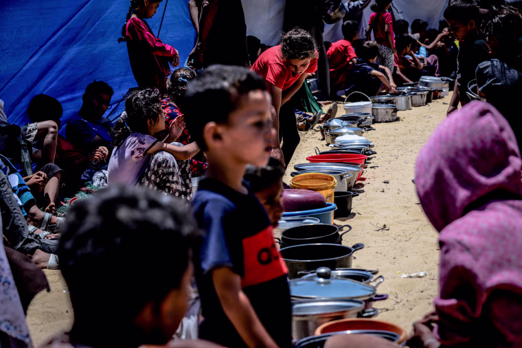 Displaced Palestinians queue for hot meals amid worsening crisis in Gaza.