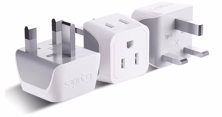 A U.K. to U.S. plug adapter, shown sitting on three different sides