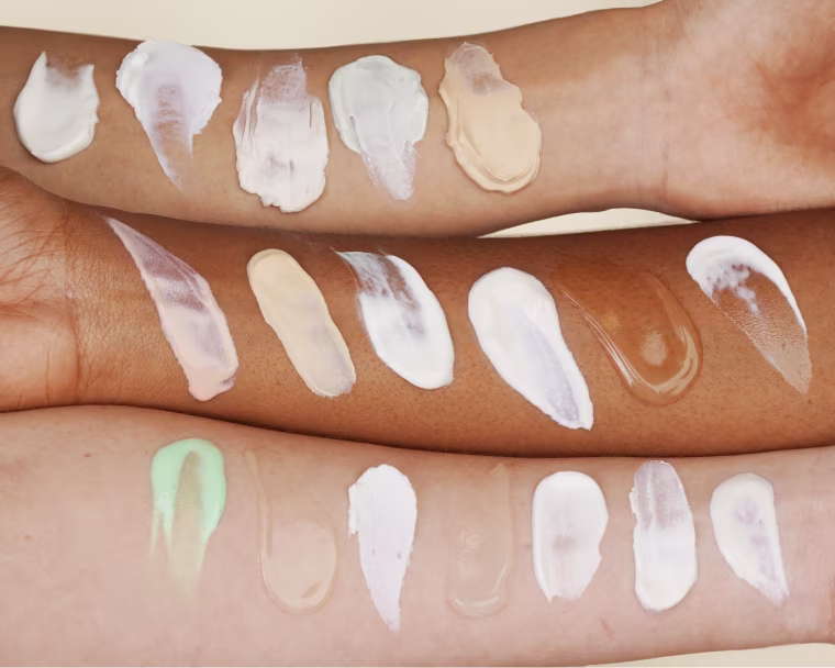 3 arms swatched with different sunscreen textures