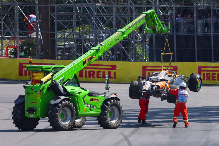 Marshals remove the car of Lando Norris.