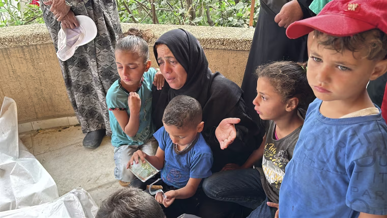 Reda Abdel Rahim Eljara mourns over her sons who were killed by an Israeli strike on the first day of Eid al-Adha.
