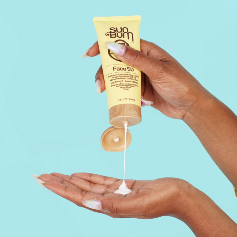 Woman squeezing drop of Sum Bum’s Daily Face Liquid Lotion Sunscreen onto hand