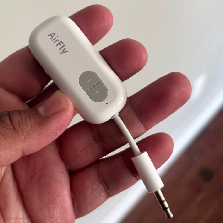 Person holding the Twelve South AirFly SE Bluetooth Audio Adapter with left hand.