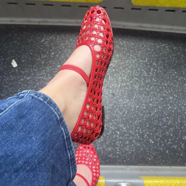 Woman wearing red woven flats