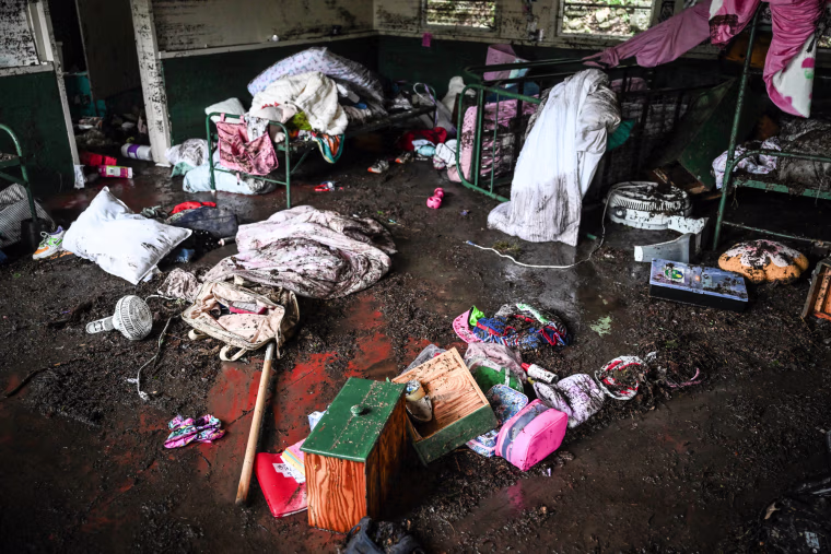 A muddy room with items strewn everywhere on the floor