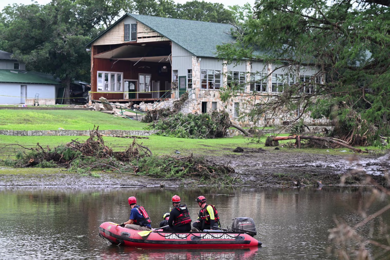 A search and rescue team looks near a damaged building at Camp Mystic in Hunt, Texas, on July 7, 2025.