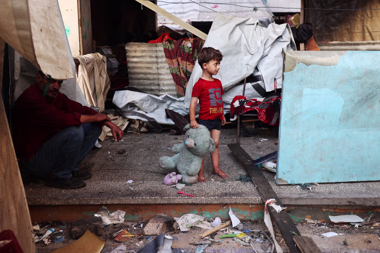 A Palestinian child at a school sheltering displaced civilians