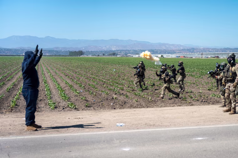 Federal immigration agents toss tear gas at protesters