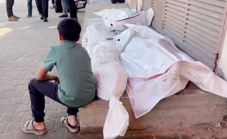 A grieving child mourns the loss of a loved one outside Al-Aqsa Hospital in Deir al-Balah, Gaza, following an airstrike Thursday.