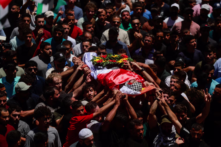 Mourners take part in the funeral of of Sayfollah Kamel Musallet, killed amid the Israel-Gaza conflict, near Ramallah