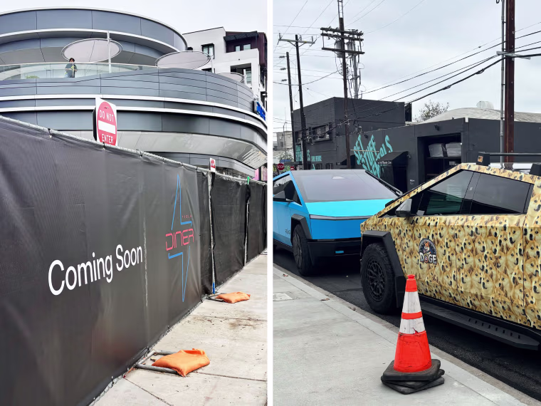 At mid-day, a "Coming Soon" fence around the perimeter of the diner and cybertrucks parked on the street by the diner.