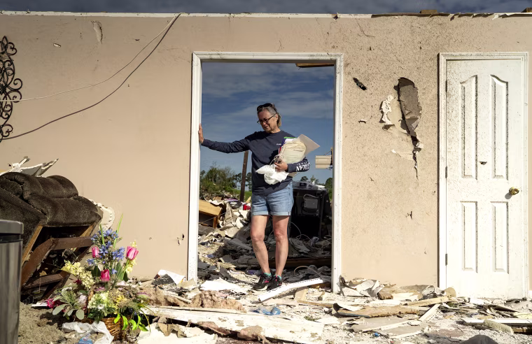 Lesly Karen Cornett stands among the debris of her house outside London, Ky., on May 18. 