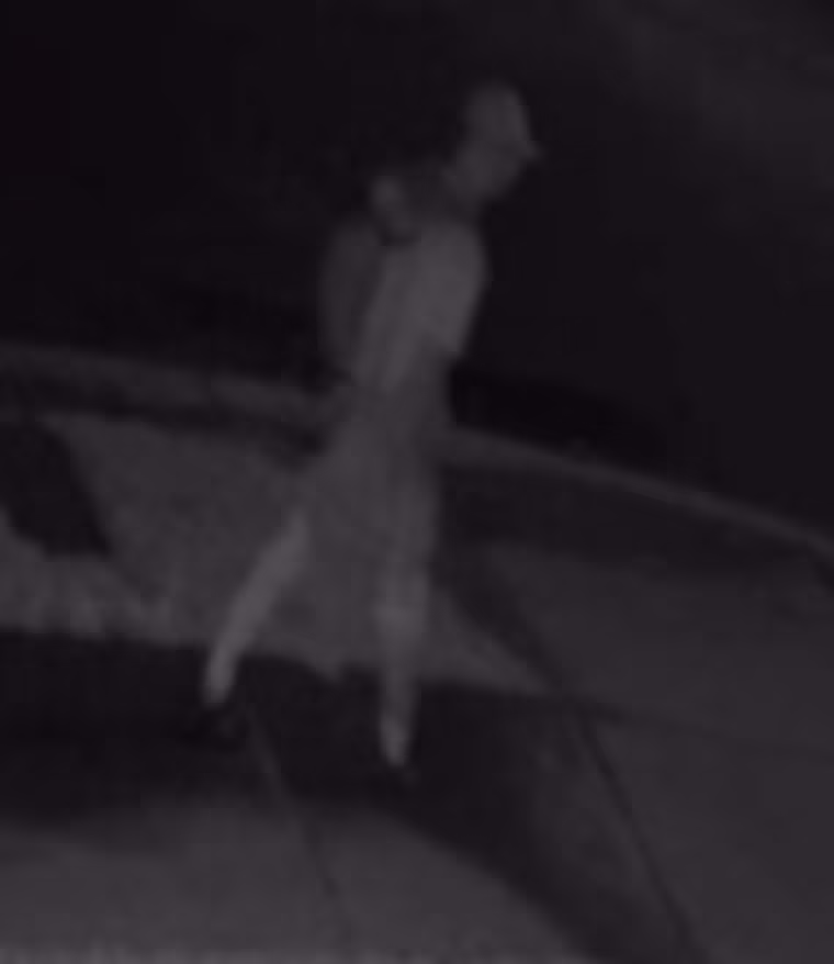 Lucien on security camera walking down his street 