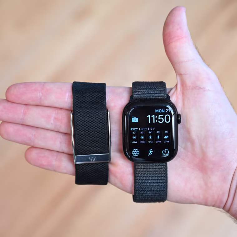 A close-up of the Whoop MG and Apple Watch Series 10 in the hand of the writer.