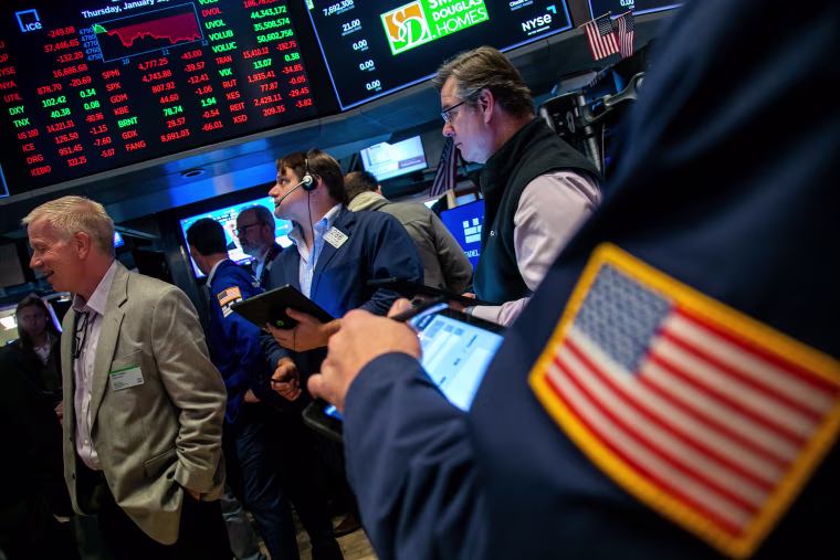 Traders work on the floor of the NYSE
