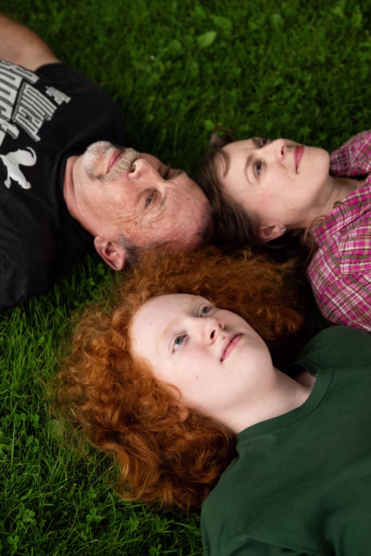 The Safford family lying on the grass.