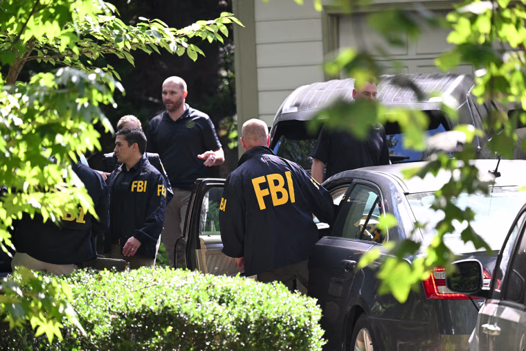 Agents outside John Bolton's house after the FBI conducted a court-authorized search on Aug. 22, 2025 in Bethesda, Md. 