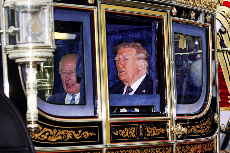 Donald Trump next to King Charles inside of a carriage