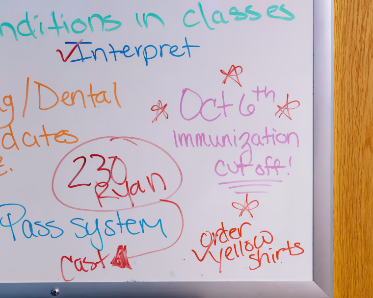 A dry erase board hangs in the office of Virginia Wilson at Premier Charter School in St. Louis, Mo., on Sept. 8, 2025.