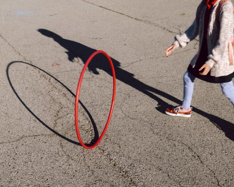 Lucy Pratt plays with a hula hoop 