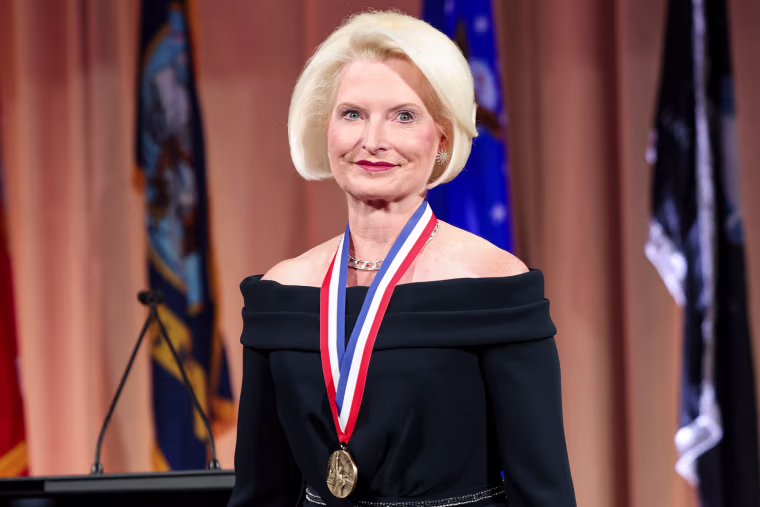 Callista Gingrich smiles and wears a medal