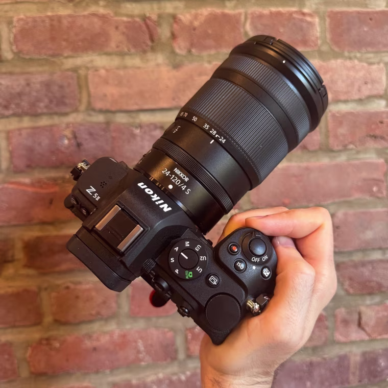 The Nikon Z5II with the Nikkor 24-120mm f/4 S lens attached against a brick wall background.