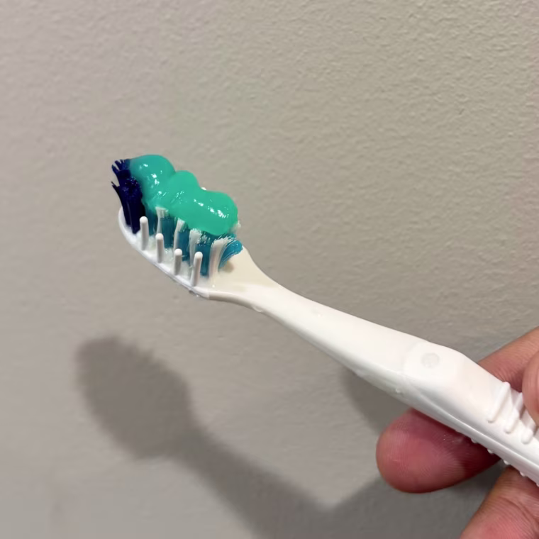 OpalescenceTeeth Whitening Toothpaste on a toothbrush.