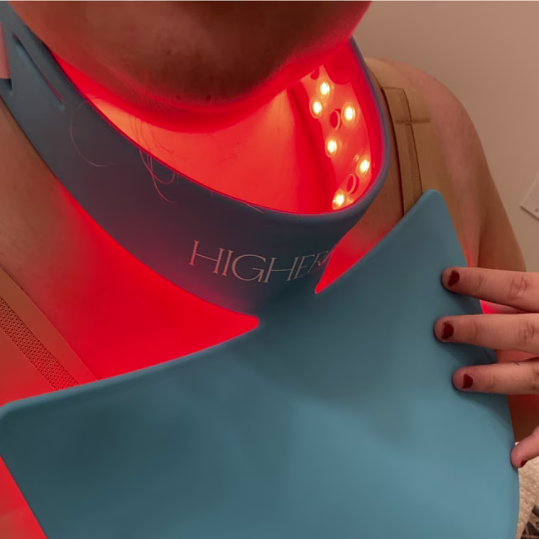 Shigo putting the HigherDOSE Red Light Neck Enhancer to good use