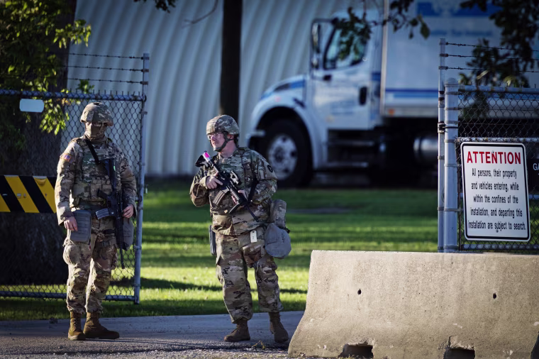 Members of the Texas National Guard stand guard at an army reserve training facility in Elwood, Ill.