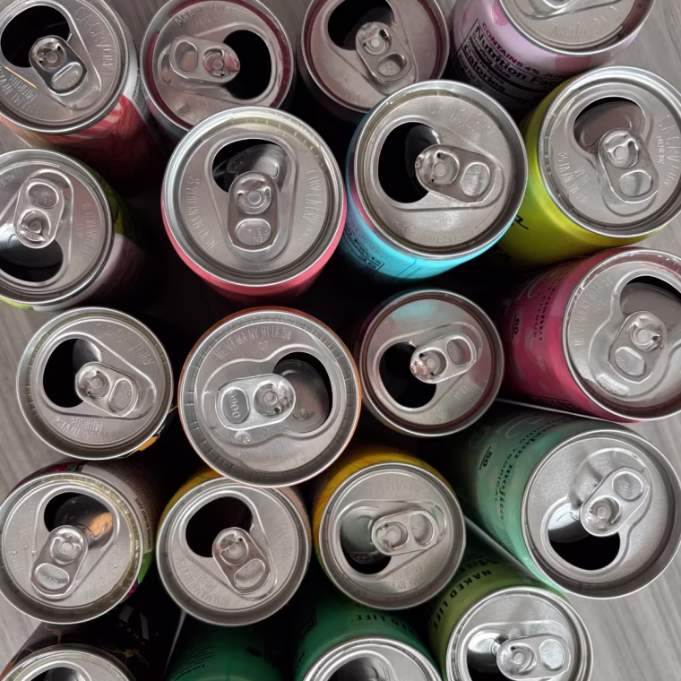 An overhead shot of canned mocktails opened.