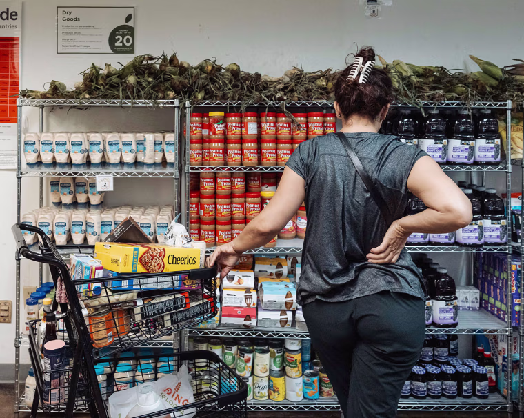 A resident browses donated food items in the pantry at Feeding South Florida in Pembroke Park on Friday, Oct. 31, 2025. 