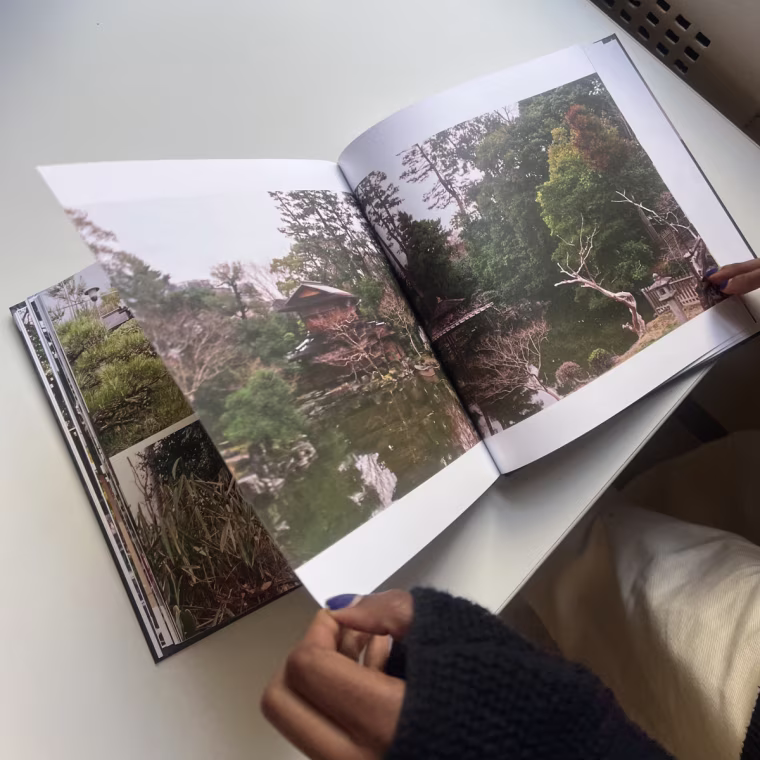 Woman flipping through a Mixbook photo book