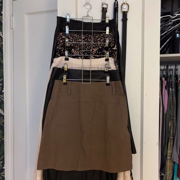 Pants and skirts hung on Lumigens Pant Hangers with Clips.